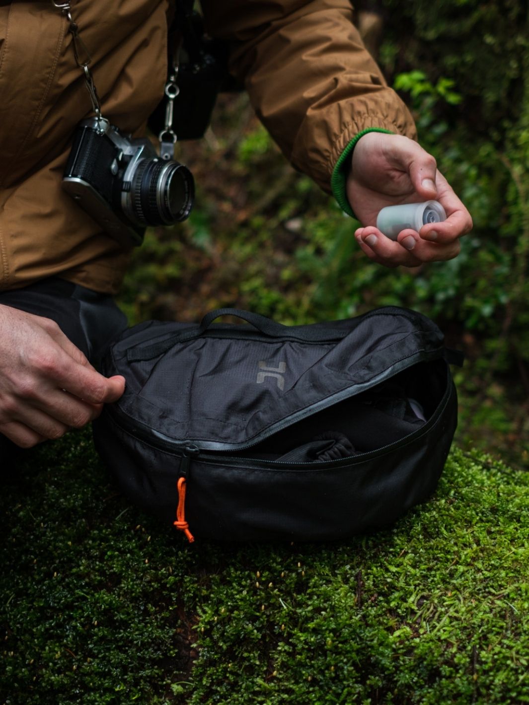 Someone grabbing a protective packstack out of their backpack