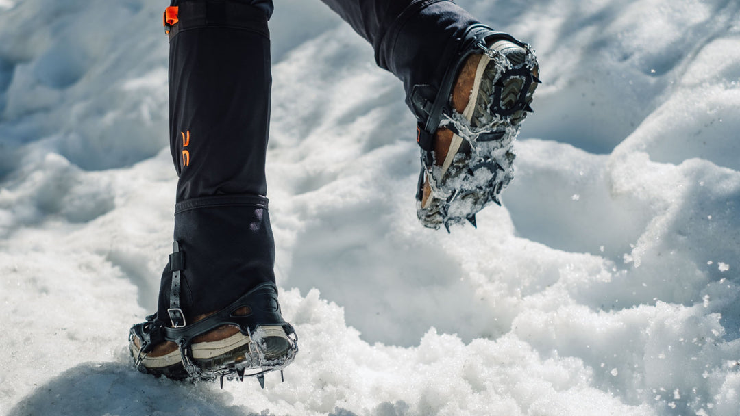 Someone running through snow wearing crampons