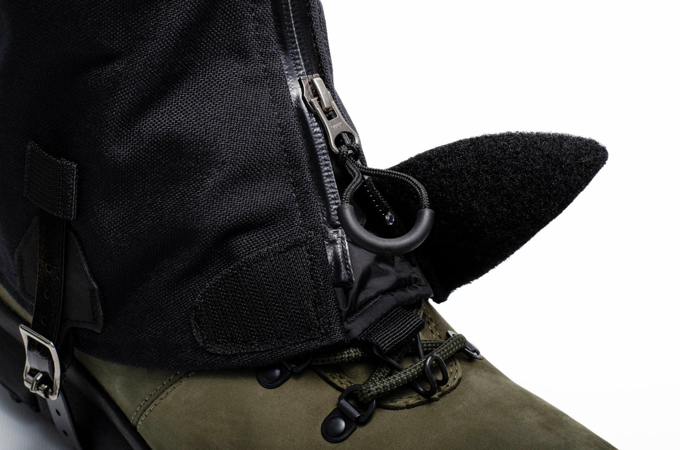 Close up of the zipper, velcro closure, and lace hook at the base of the gaiter